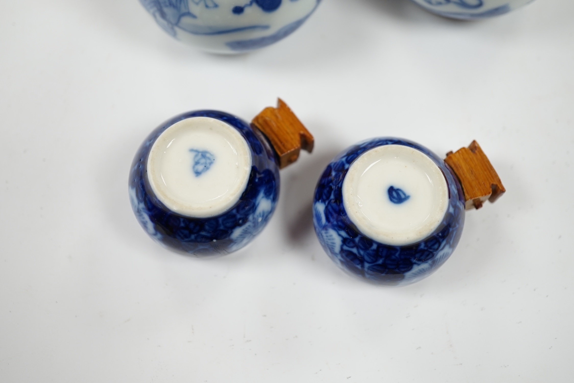Four Chinese blue and white porcelain bird feeders, largest 7cm high. Condition - good, some glue residue